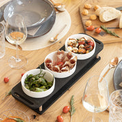 HOTTY TapasBar set with ceramic bowls on a wooden board, ideal for organized serving of tapas and snacks.