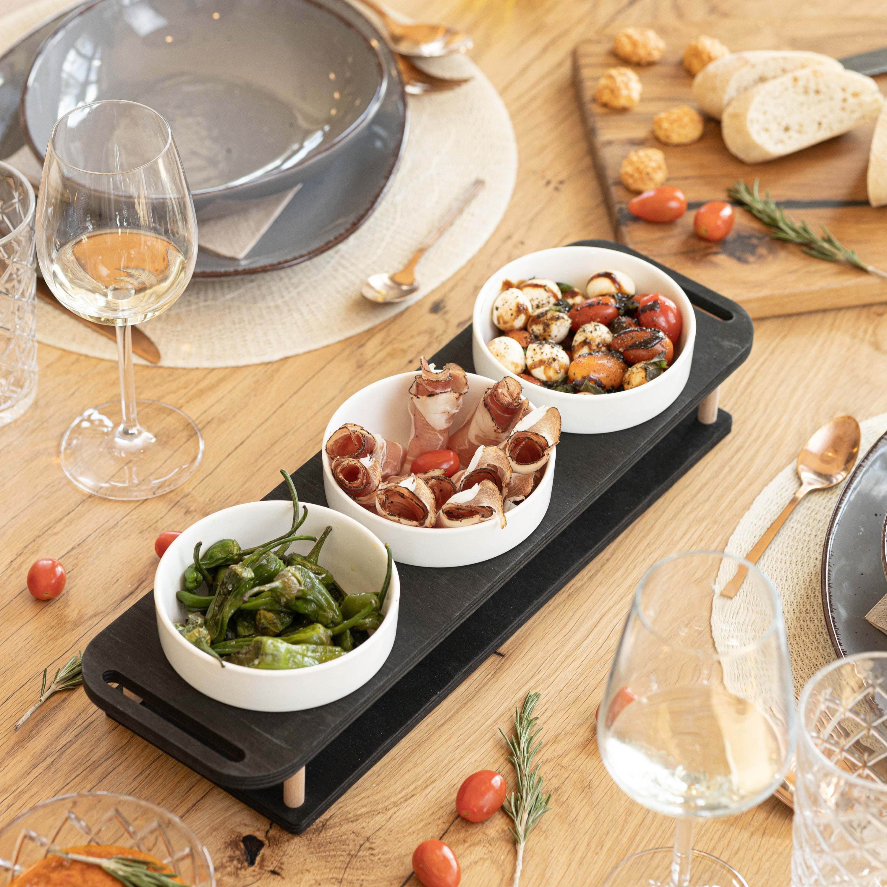 HOTTY TapasBar set with ceramic bowls on a wooden board, ideal for organized serving of tapas and snacks.