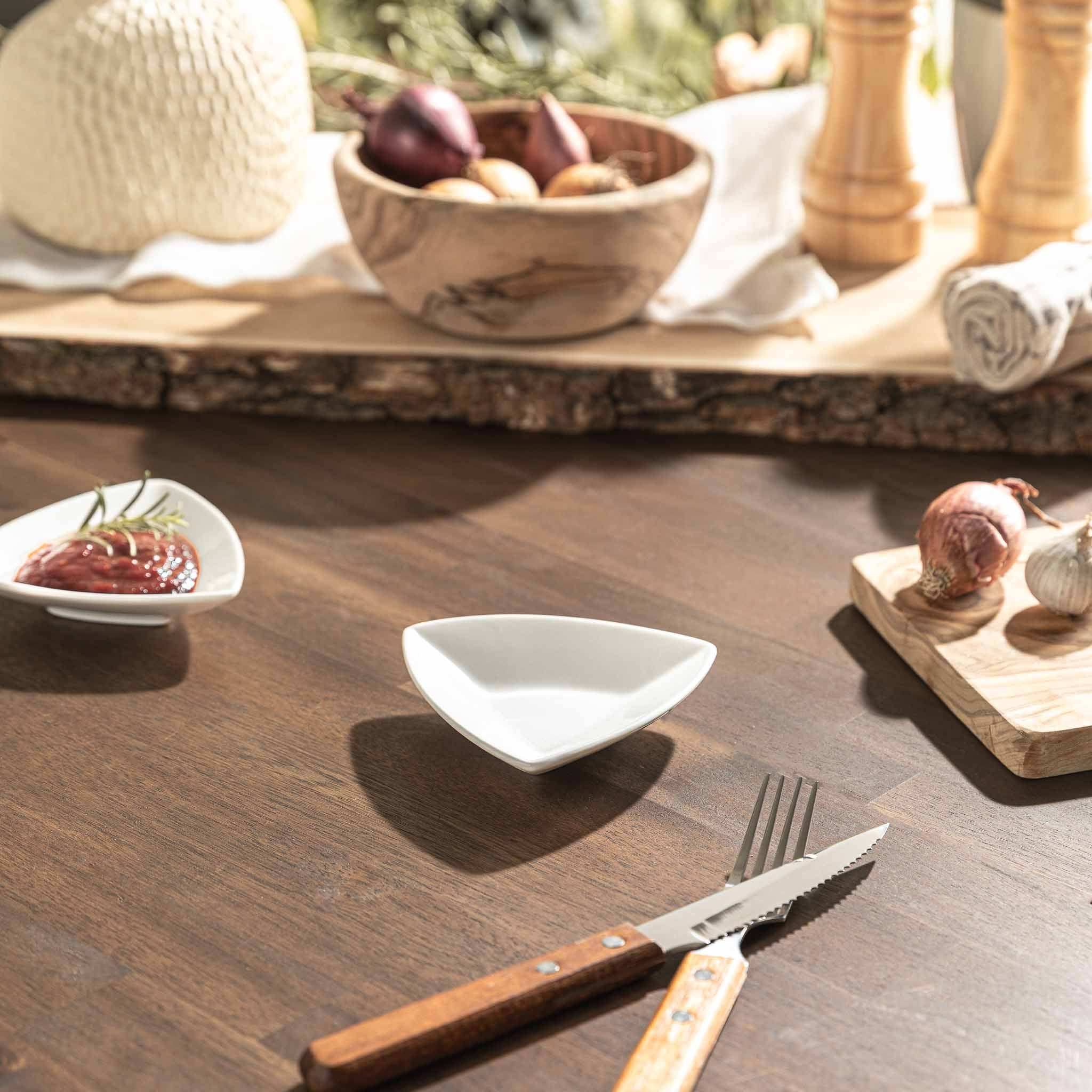 Mini Tapas Bowl on rustic table with cutlery and food accompaniments.